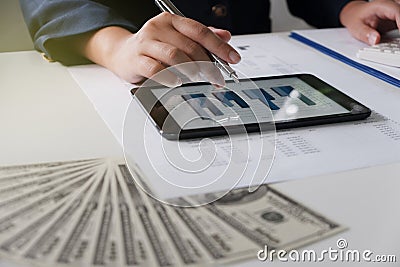 Women working in office. financial analysis with charts on tablet for business, accounting, insurance or finance concept. Stock Photo