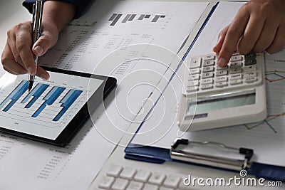 Women working in office. financial analysis with charts on tablet for business, accounting, insurance or finance concept. Stock Photo