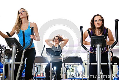 Women working out on spinning bikes at the gym Stock Photo