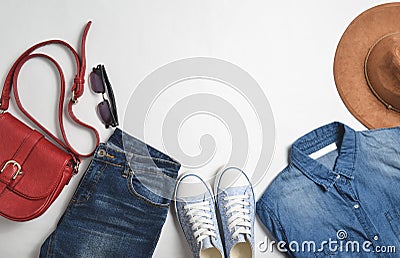 Women& x27;s fashion clothing and accessories. Jeans, denim shirt, sneakers, felt hat, leather bag, sunglasses, layout Stock Photo