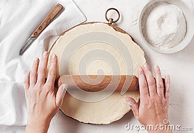 Women's hands roll the dough Stock Photo