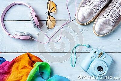 Womens desk, fashion blogger, beauty technology accessories: instant photo camera, colorful handkerchief, pink headphones and shin Stock Photo