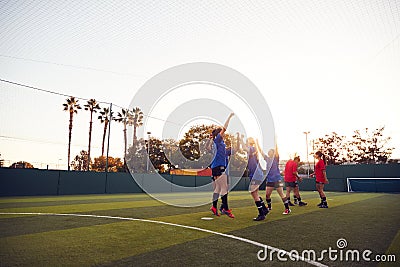 Womens Football Team Celebrating Scoring Goal In Soccer Match On Outdoor Astro Turf Pitch Stock Photo