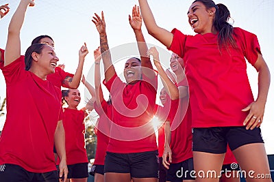 Womens Football Team Celebrating Winning Soccer Match On Outdoor Astro Turf Pitch Stock Photo