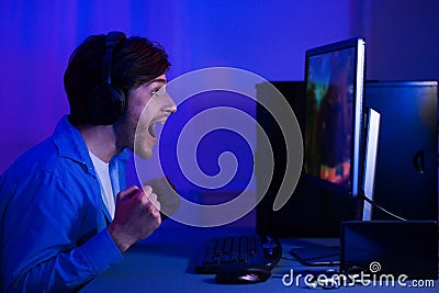 Won game. Male gamer playing game at home Stock Photo