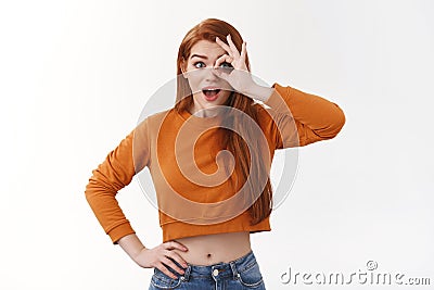 Wondered amused redhead cute enthusiastic girl ginger haircut drop jaw amazed show okay ok excellent gesture look Stock Photo