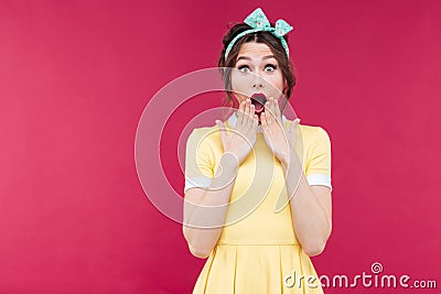 Wondered pinup girl in yellow dress with mouth opened Stock Photo