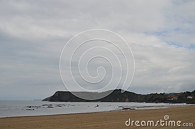 Wonderful Beach On A Cloudy Day In Comillas Stock Photo