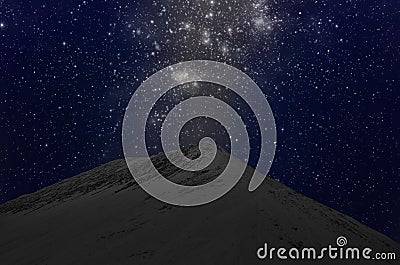 Wonderful bright stars in blue sky over sand mountain Stock Photo