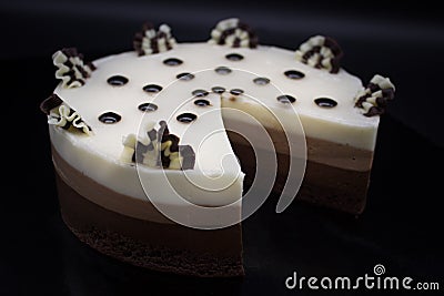 A wonderful chocolate cake. A cake of several varieties of chocolate: black, milk and white. Without one piece of cake. Pac-man Stock Photo