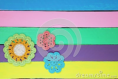 The wonderful crochet doilies on colourful wooden table Stock Photo