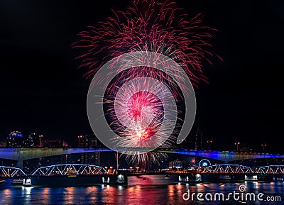 The wonderful Fireworks light up into the sky, look through the beautiful bridges and rivers with free space for text. Stock Photo