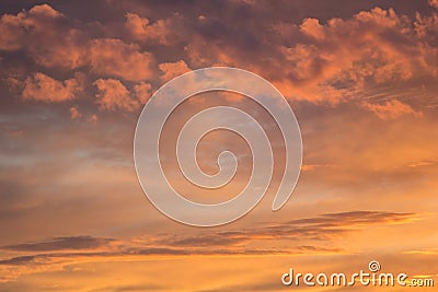 Wonderful golden and pink fluffy clouds in blue sky as abstract background, texture. Stock Photo