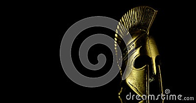 A wonderful golden spartan helmet as part of the equipment of ancient Greek soldiers Stock Photo