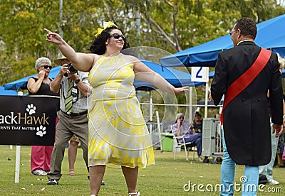 Confident, flamboyant, fun, happy plus-size woman modelling at dog show Editorial Stock Photo