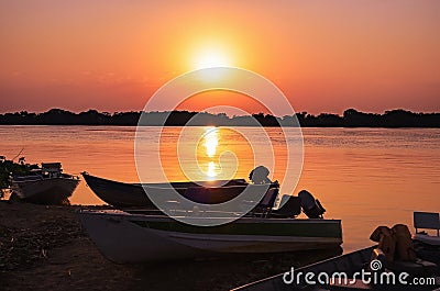 Wonderful landscape of a silhouette of boats on a amazing sunset Stock Photo