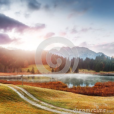 Wonderful misty landscape at Germanian Alps. Colorful Clouds on Blue Sky over the Karwendel mountains at early morning in autumn, Stock Photo