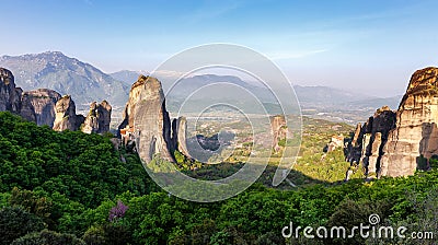 Wonderful Panoramic view of Meteora. Majestic sunny landscape with colorful sky over the fairytale mountain valley in Stock Photo