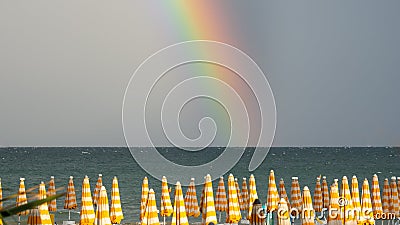 Wonderful rainbow over the Adriatic sea. Contrast between the bright colors of the rainbow and the green sea Stock Photo