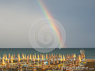 Wonderful rainbow over the Adriatic sea. Contrast between the bright colors of the rainbow and the green sea Stock Photo