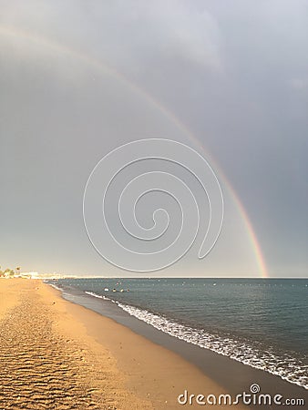 Wonderful rainbow over the sea and the beach in Turkey after heavy rain Stock Photo