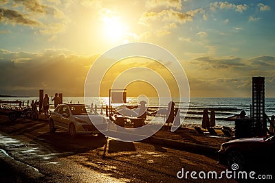 Wonderful sunset and car on road unknown couple walking Stock Photo
