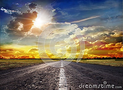 A wonderful sunset and a paved road Stock Photo