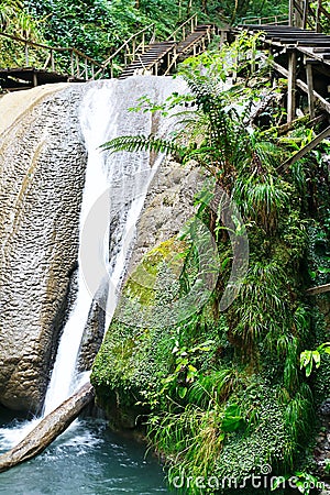 Wonderful tranquil waterfall among southern forests Stock Photo