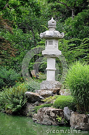 Oriental park with wunderful trees and a stone lamp Stock Photo