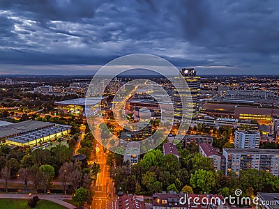 Wonderful twilight view over the illuminated Munich with business district and cars on a road from a high perspective. Stock Photo