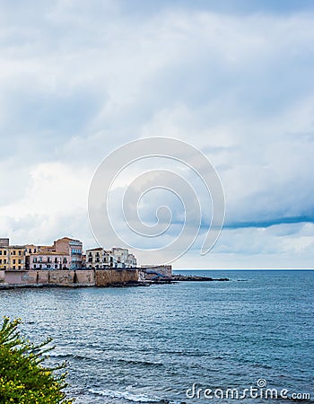 Wonderful view of the seafront of Ortigia in Syracuse on a summer day, with blue sea and cloudy sky as a backdrop Stock Photo