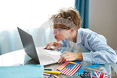 Wonk schoolboy look at screen of laptop, do homework Stock Photo