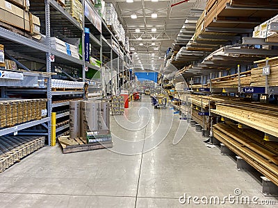 The wood aisle at Lowes home improvement store with stacks of lumber waiting for customers to purchase Editorial Stock Photo