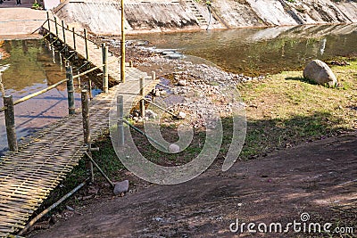 Wood Bamboo Bridge across the Canal in countryside Stock Photo