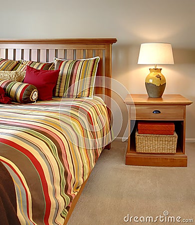 Wood bed and nightstand with stripes Stock Photo