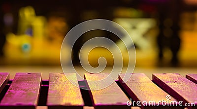 Wood bench on blur background with night light. Stock Photo