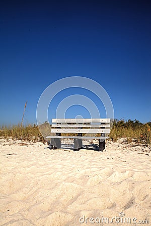 Wood bench on the white sand beach of Delnor-Wiggins Pass State Stock Photo