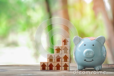 Wood block stacking as step stair and piggy bank, business growth to success. Stock Photo