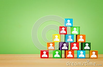 wood blocks pyramid with people icons, human resources and management concept Stock Photo