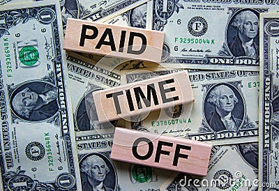 Wood blocks with text `paid time off` on a beautiful background from dollar bills. Business concept, copy space Stock Photo