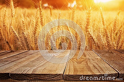 Wood board table in front of field of wheat on sunset light. Ready for product display montage Stock Photo