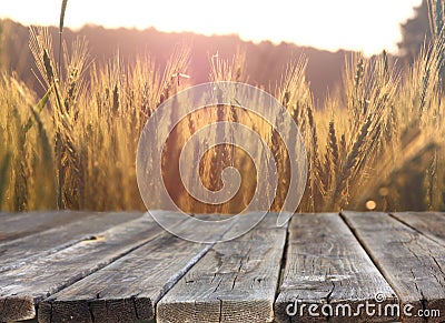 Wood board table in front of field of wheat on sunset light. Ready for product display montages Stock Photo