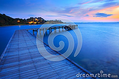 Wood bridge pier into blue sea at morning time Stock Photo