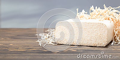 Wood briquette from wood shavings. biofuel ecological alternative fuel. Stock Photo