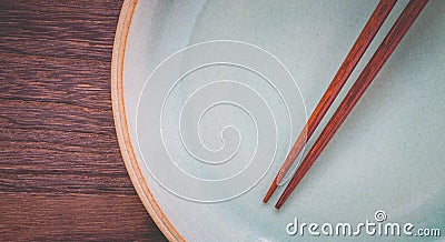 Wood brown chopsticks and celadon green ceramic Stock Photo