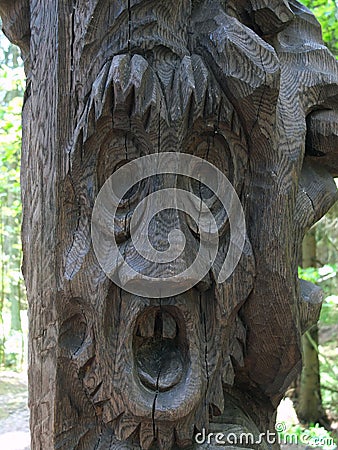 Wood carved frightened face. Stock Photo