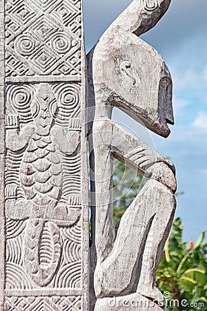 Wood carved sitting man and pattern with lizard Stock Photo