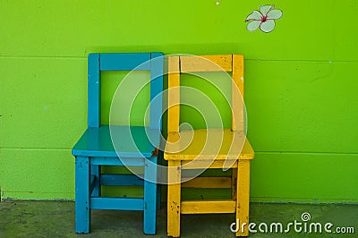 Wood chair against green wall Stock Photo