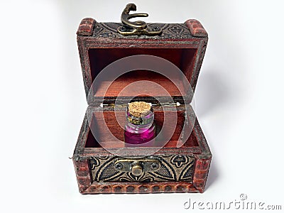Wood chest with potion pink. old treasure casket isolated on white background. Alchemy set with flasks. small glass bottles with Stock Photo