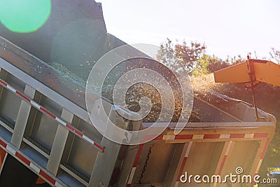 Wood chipper blowing tree branches cut a portable machine used for reducing wood into smaller wood chips Stock Photo